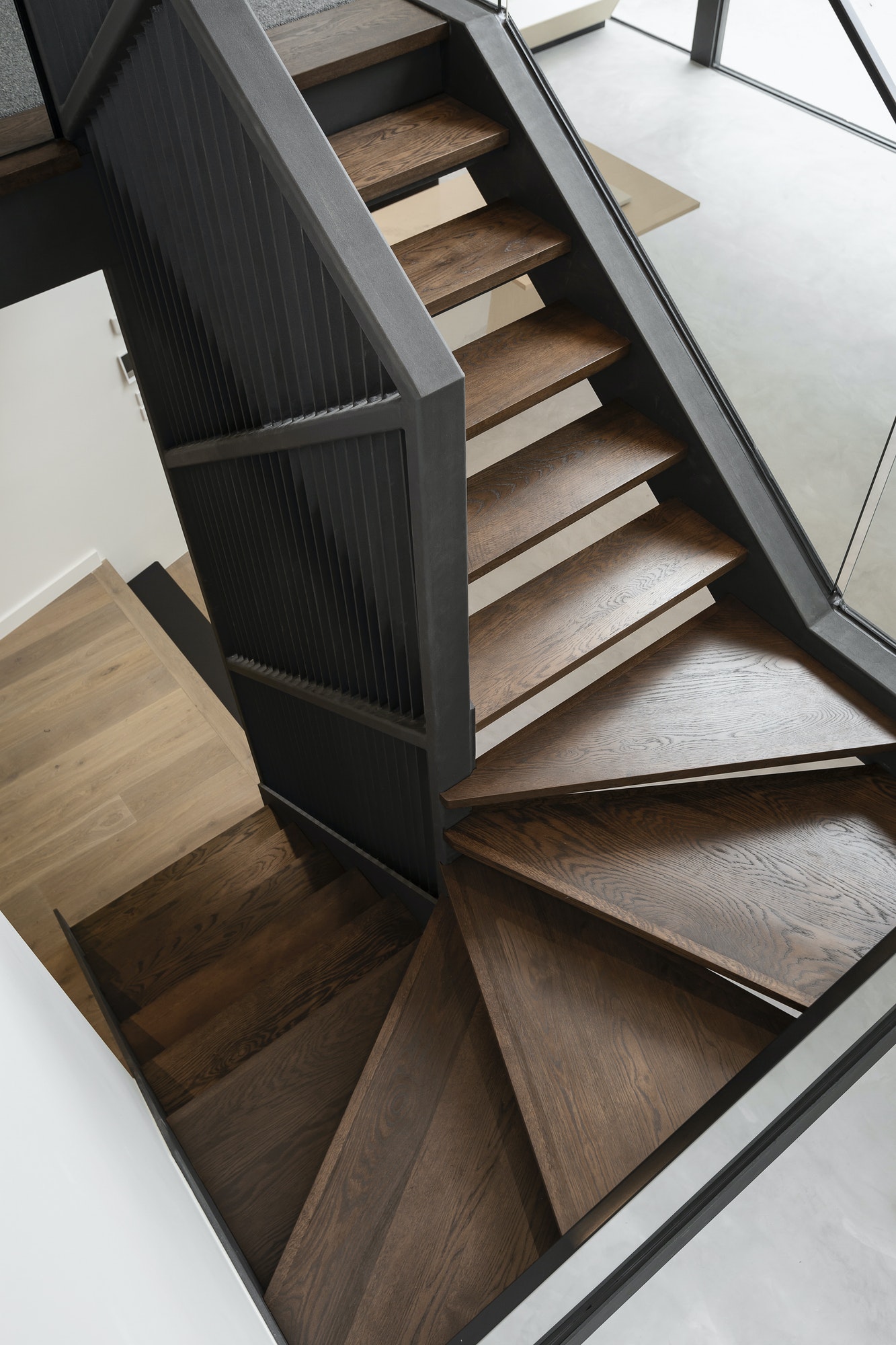 Dark wooden stairs inside of modern home