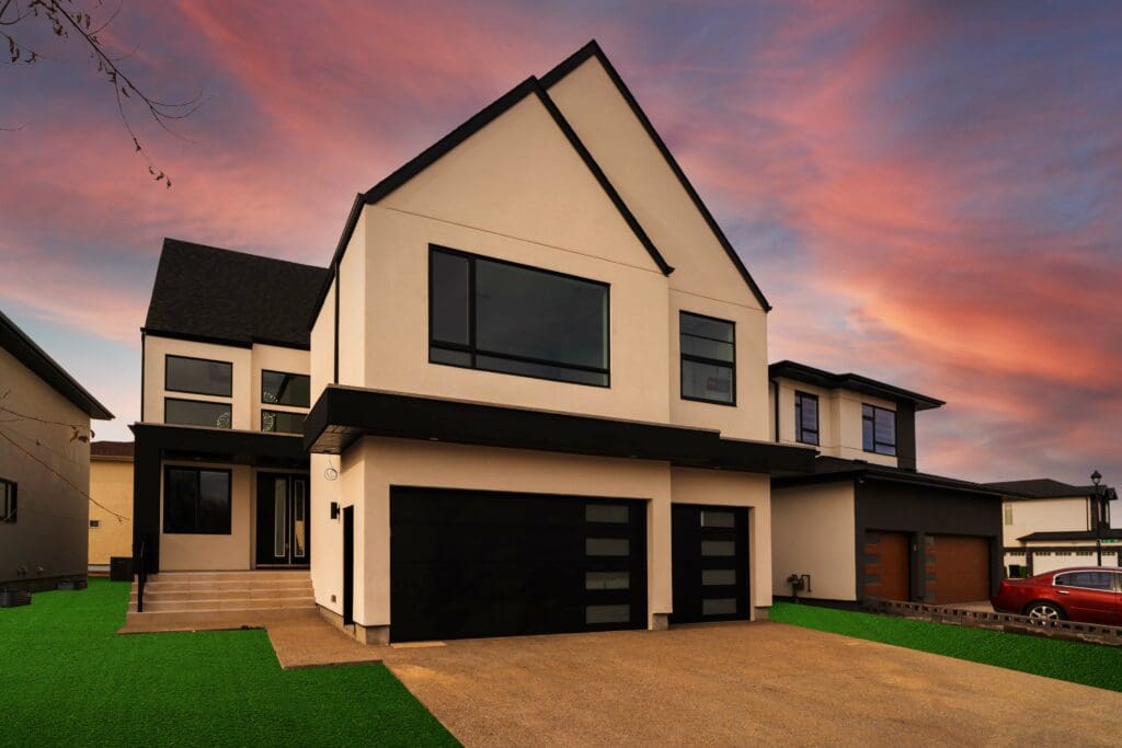 A show home with a garage and a sunset.